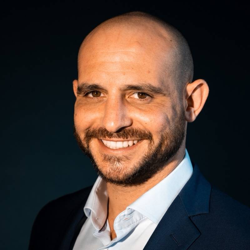 Jonathan Zacharie, founder of Life Story, smiling in a navy jacket.