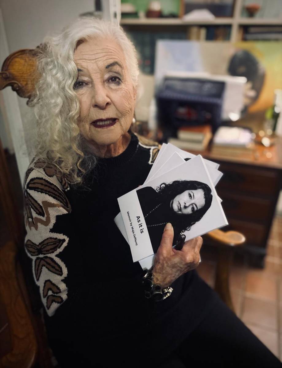 Maja holding printed copies of her memoir As It Is.